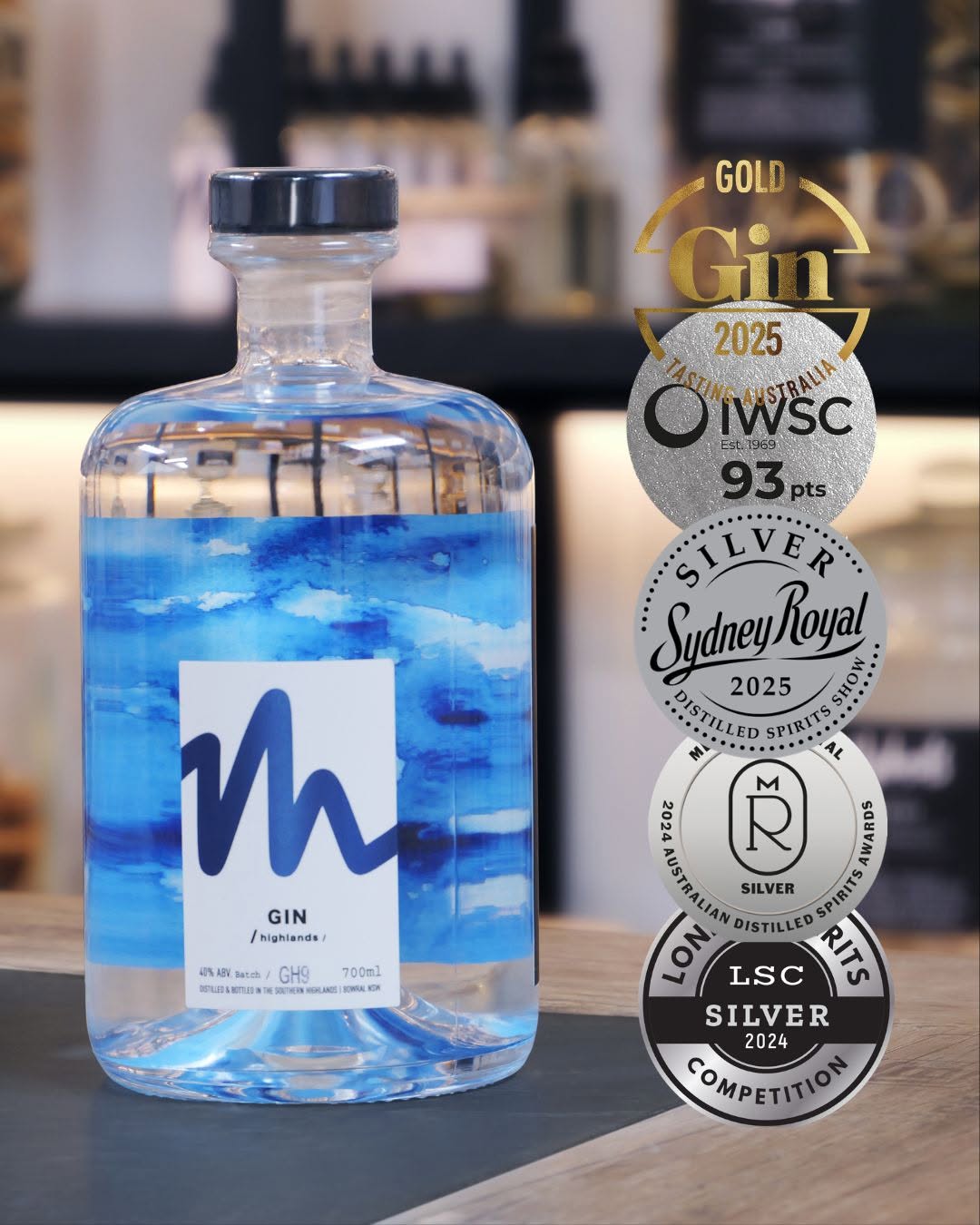 Bottle of Millsheds gin with award medals, including IWSC 93 points and a Sydney Royal 2025 silver